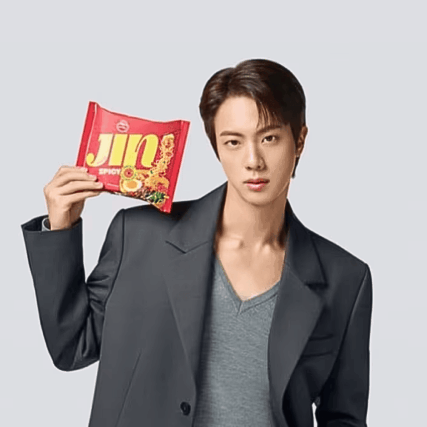 BTS K pop superstar Jin holds a packet of spicy Jin ramen